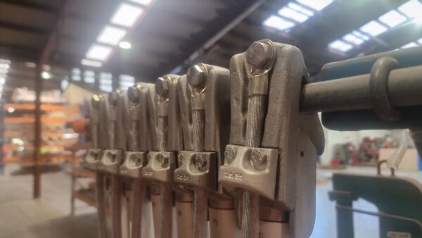 Line Clamp 38s on the production line. Showing the protective saddle that reduces stress on the cable-clamp connection.